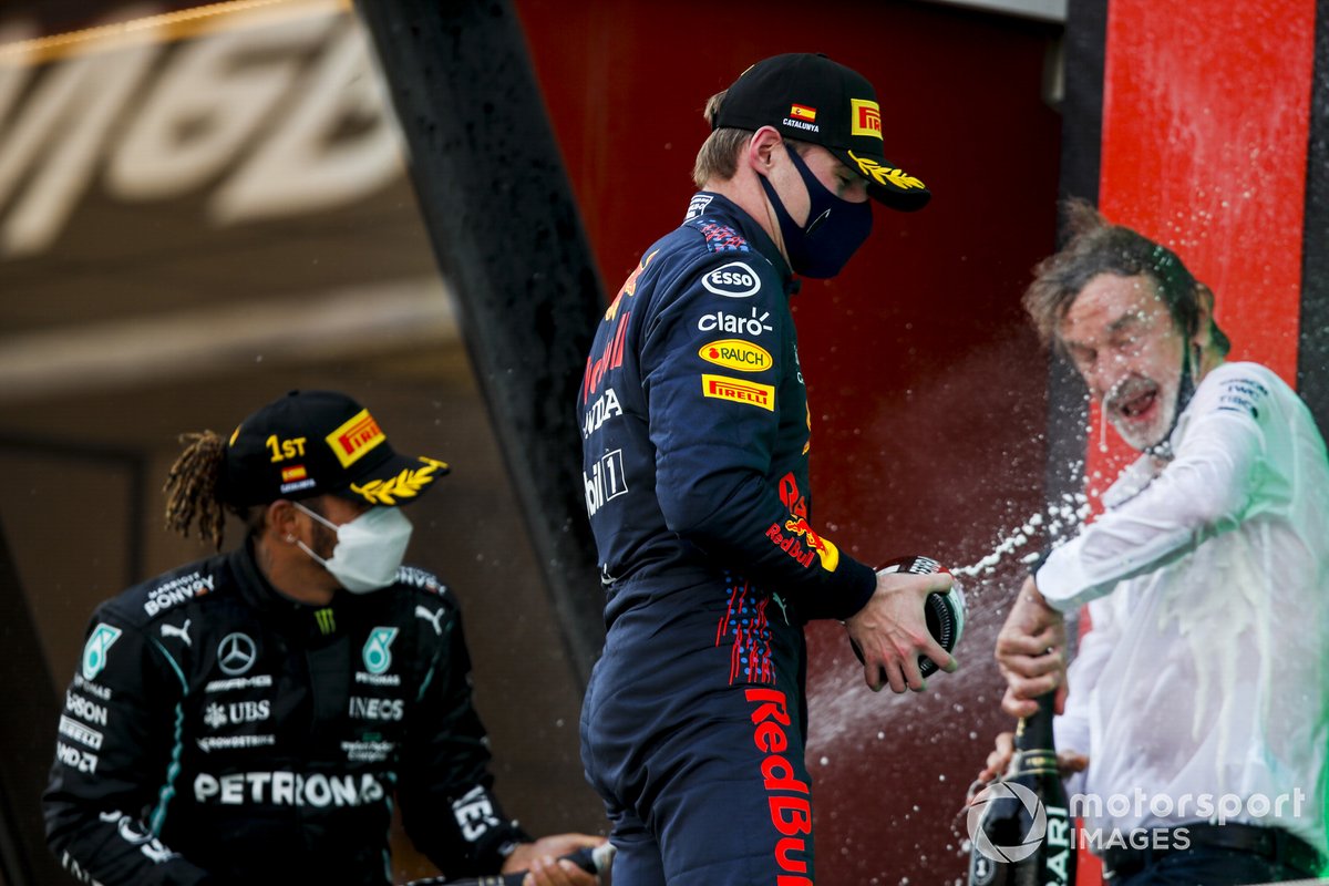 Lewis Hamilton, Mercedes, 1st position, and Max Verstappen, Red Bull Racing, 2nd position, spray Champagne at the Mercedes trophy delegate on the podium