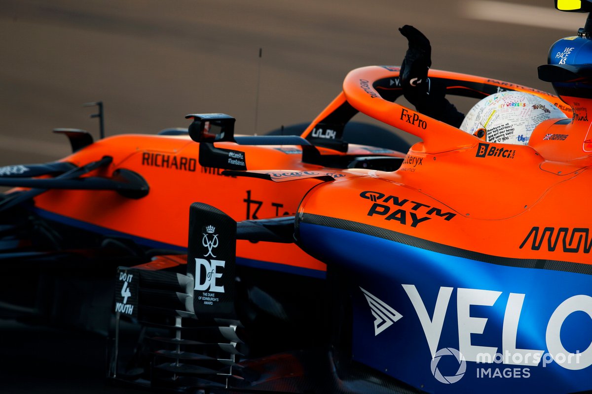 Lando Norris, McLaren MCL35M, waves from his cockpit on his way to Parc Ferme