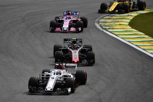 Marcus Ericsson, Sauber C37 leads Kevin Magnussen, Haas F1 Team VF-18 Kevin Magnussen, Haas F1 Team VF-18 and Sergio Perez, Racing Point Force India VJM11 