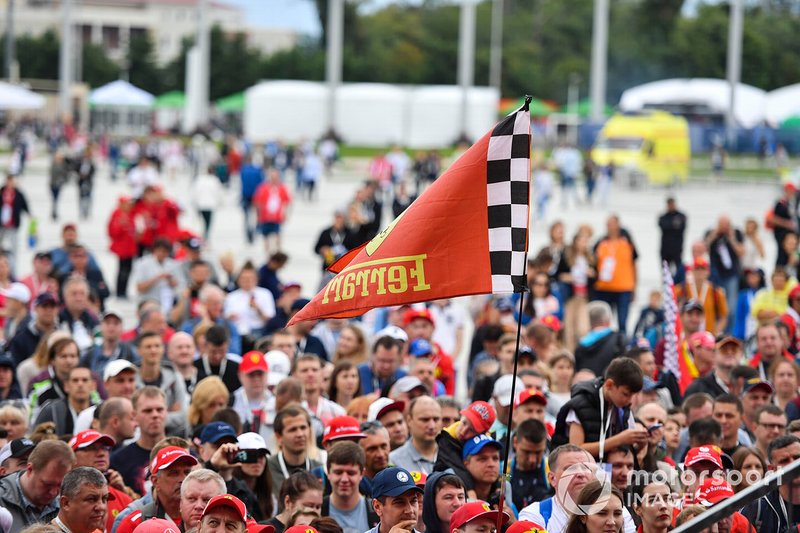 A fan holds a Ferrari flag