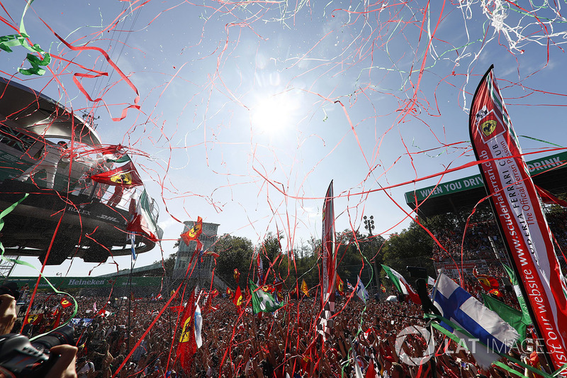 Streamers fall as the top three drivers celebrate on the podium, Champagne