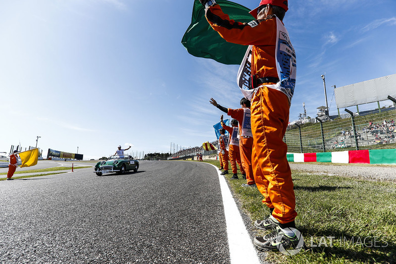 Marshals line the track as Esteban Ocon, Force India, passes in the driving parade