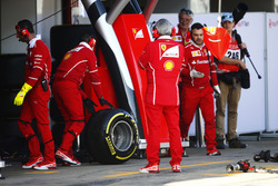 A Pirelli tyre from a Ferrari s wheeled by a mechanic in the pit lane