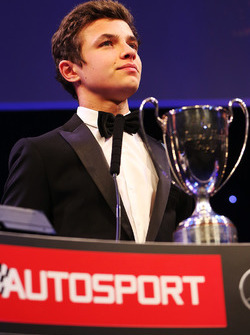 Lando Norris is presented with the British Club Driver of the Year trophy
