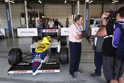 Nigel Mansell is interviewed next to a Williams FW11 Honda