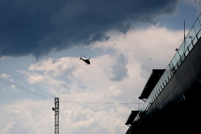 A helicopter fly's over the track
