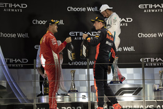 Sebastian Vettel, Ferrari and Max Verstappen, Red Bull Racing celebrate on the podium with the champagne