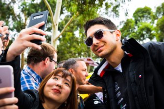 Esteban Ocon, Mercedes AMG F1, has his photo taken with a fan