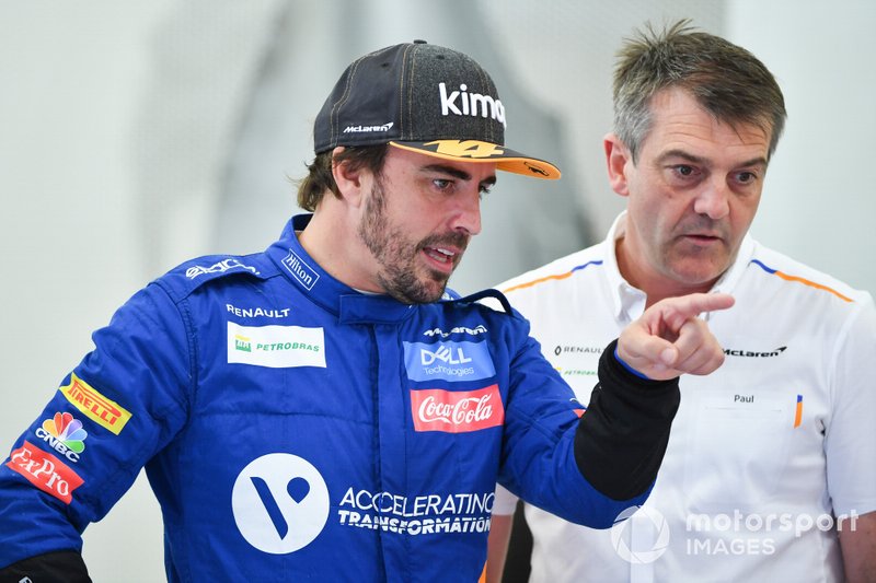 Fernando Alonso, McLaren, talks to a team member 