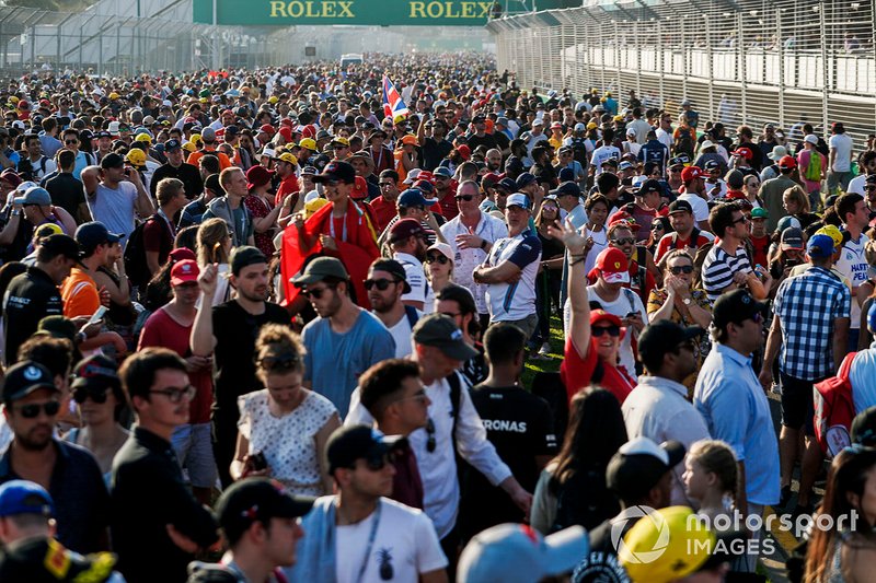 Fans flood the circuit after the race