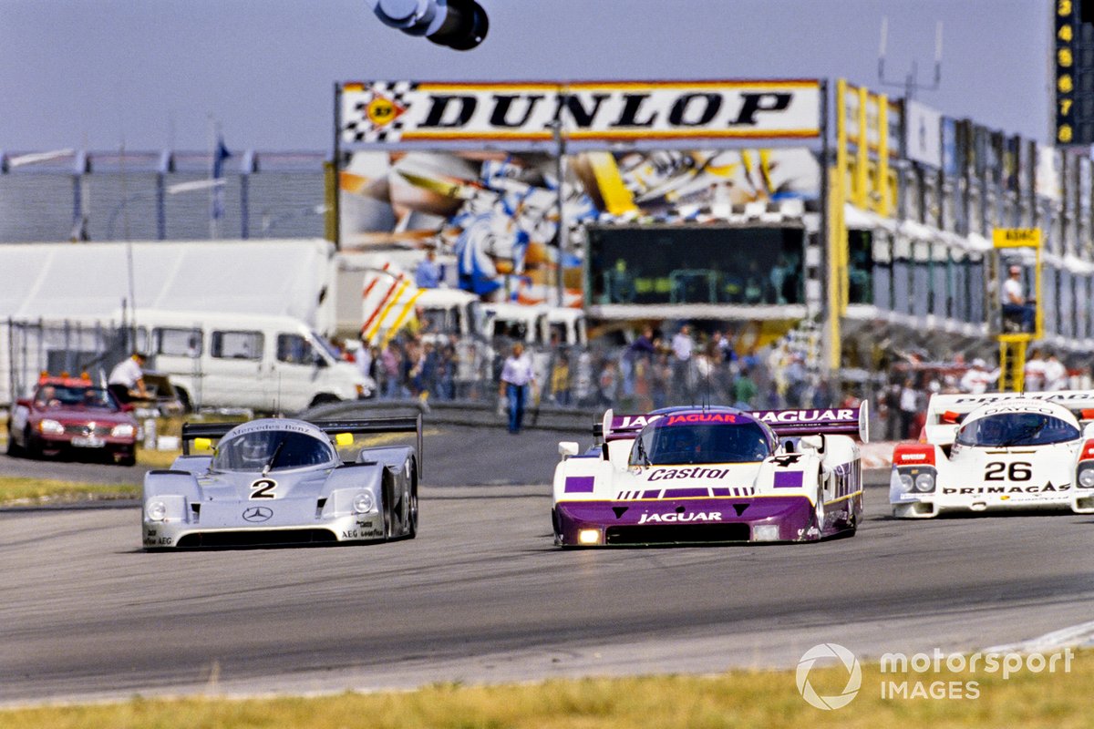 Michael Schumacher, Jochen Mass, Mercedes-Benz C11, passes Jan Lammers, Andy Wallace, Jaguar XJR-11