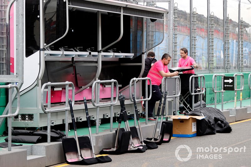 Racing Point personnel pack away their equipment on the pitwall