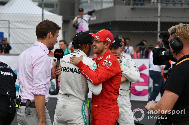 Jenson Button, Sky Sports F1, interviews Lewis Hamilton, Mercedes AMG F1, 1st position, and Sebastian Vettel, Ferrari, 2nd position, after the race