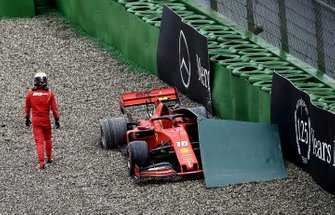 Charles Leclerc, Ferrari, walks away from his car after crashing out of the race