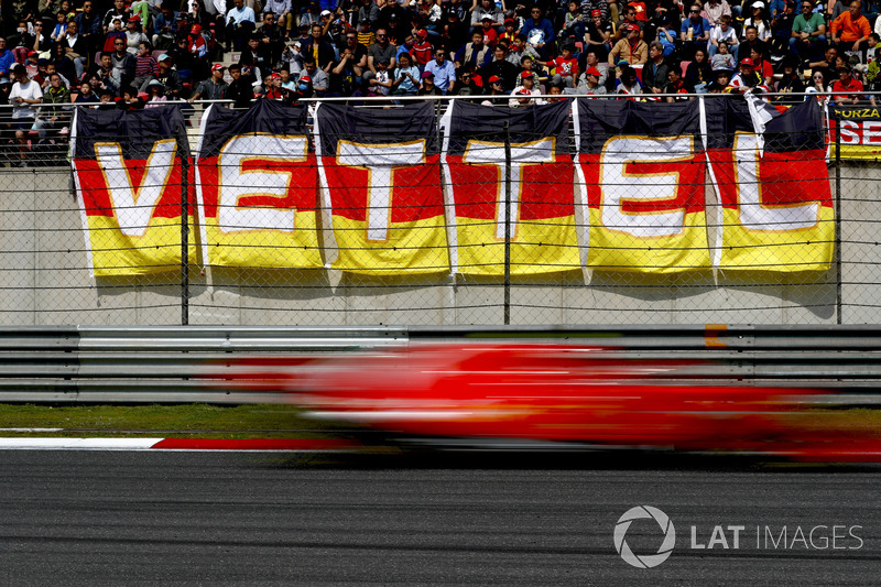 Sebastian Vettel, Ferrari SF71H, flashes past fans in a grandstand