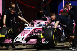 Sergio Perez, Force India, is wheeled into his pit garage by mechanics