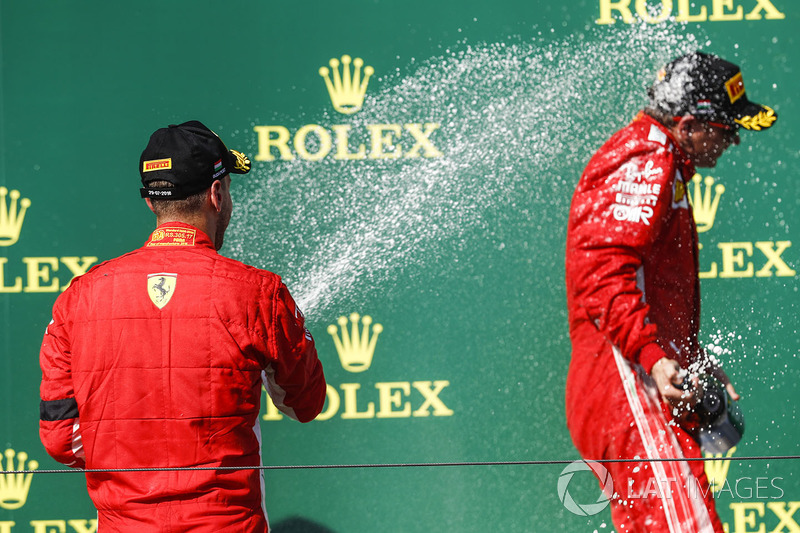 Sebastian Vettel, Ferrari, 2nd position, sprays Kimi Raikkonen, Ferrari, 3rd position, with Champagne
