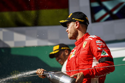 Sebastian Vettel, Ferrari celebrates by spraying champagne on the podium