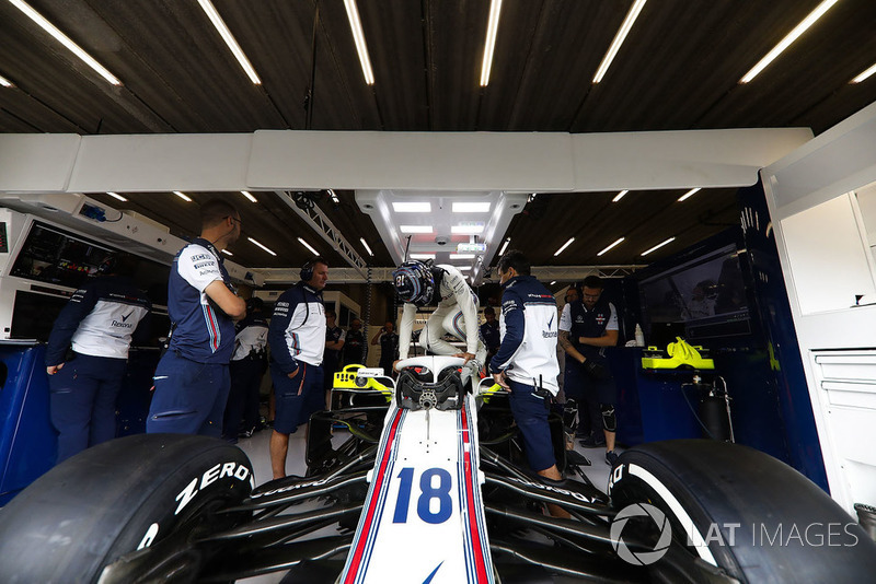 Lance Stroll, Williams FW41, climbs in to his car