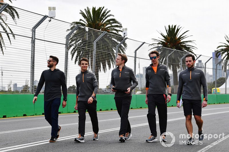 Lando Norris, McLaren, walks the track with his team