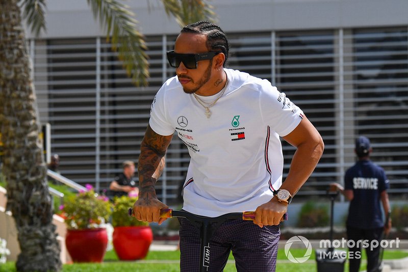 Lewis Hamilton, Mercedes AMG F1 arrives on a scooter in the paddock