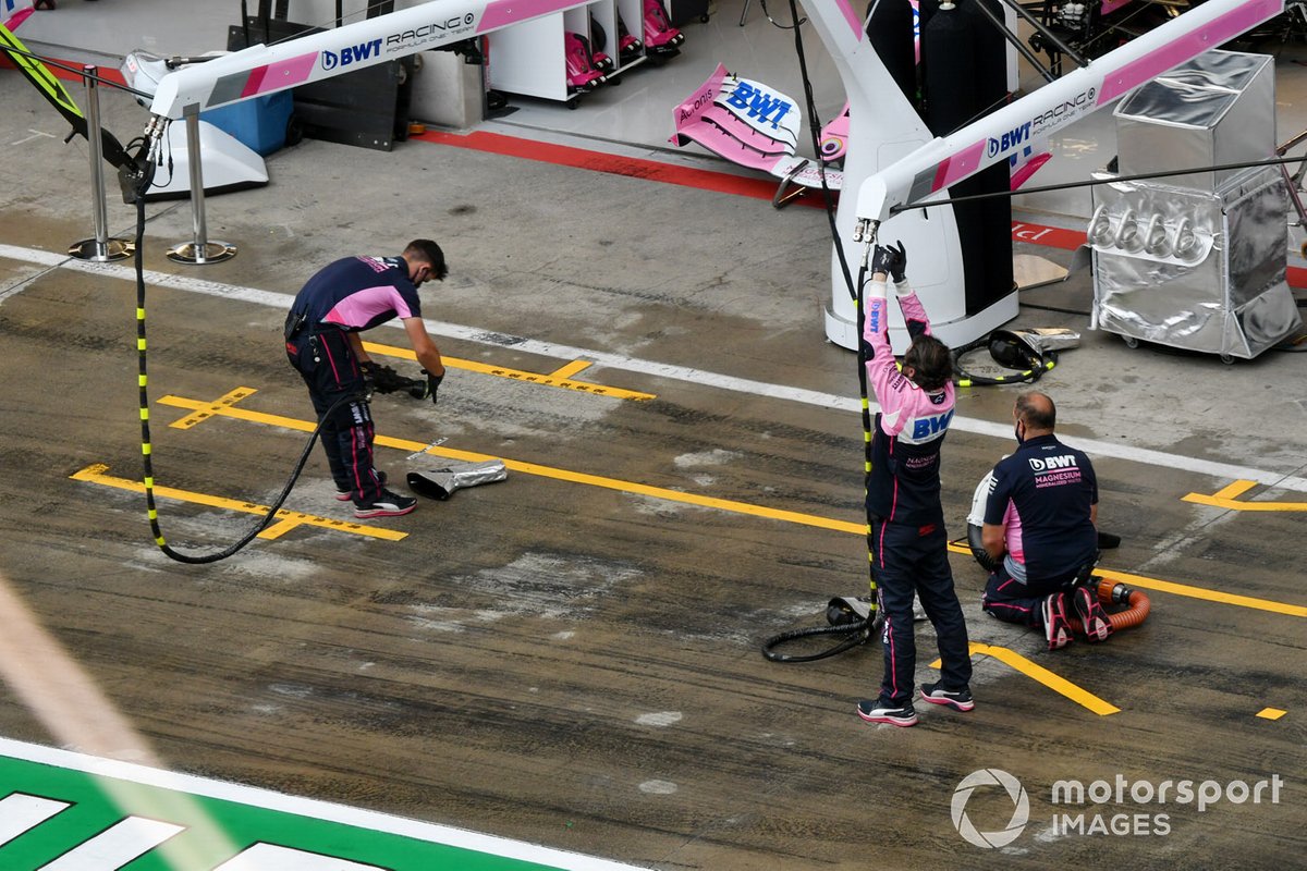 Racing Point team dry the pit lane