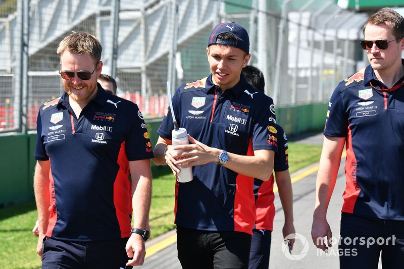 Alex Albon, Red Bull Racing walks the track with members of his team