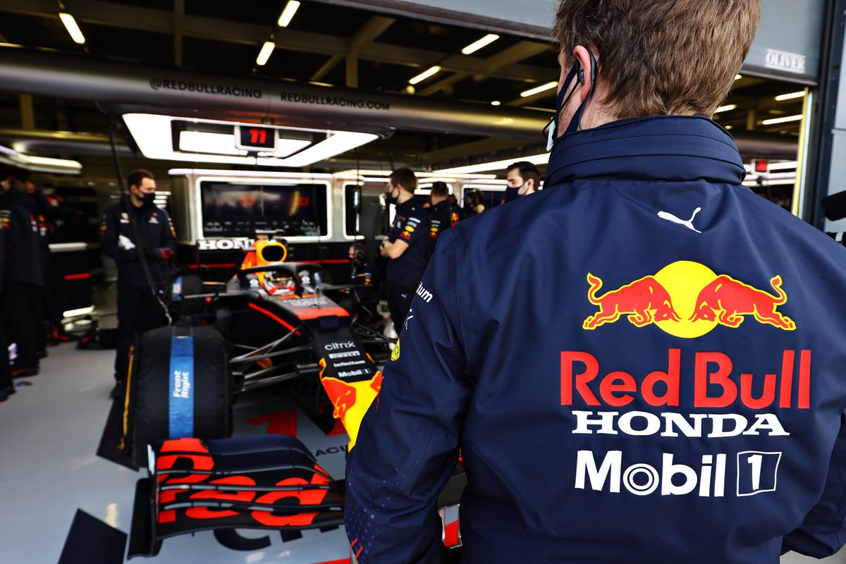 A member of the Red Bull Racing team works in the garage