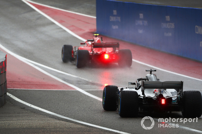 Kimi Raikkonen, Ferrari SF71H, leads Lewis Hamilton, Mercedes AMG F1 W09 EQ Power+, out of the pits