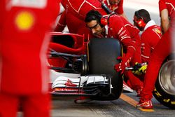 A mechanic changes a front wheel during a pit stop on the Sebastian Vettel Ferrari SF70H