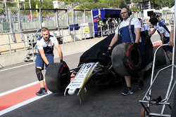 The crashed car of Felipe Massa, Williams FW40 is recovered in FP1 and pushed down pitlane by mechanics