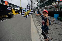 Young fan with checkered flag, atmosphere