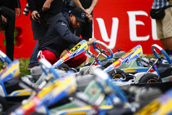 Lewis Hamilton, Mercedes AMG F1, examines a kart