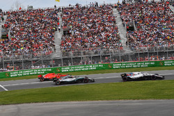 Kimi Raikkonen, Ferrari SF71H exits pit lane behind Lewis Hamilton, Mercedes-AMG F1 W09