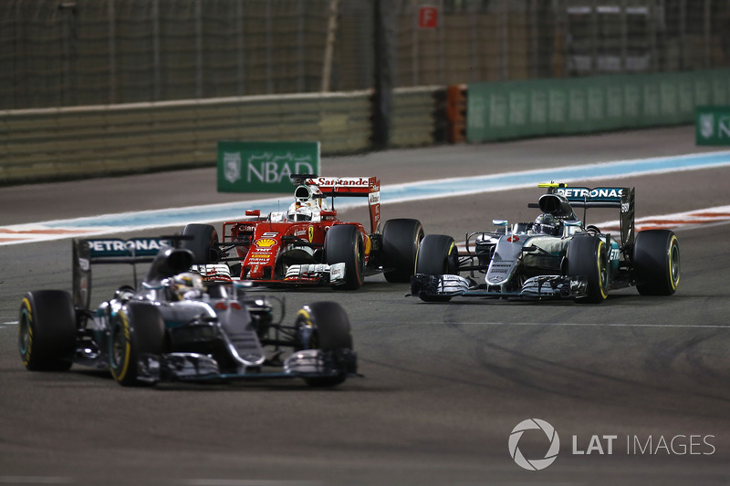 Sebastian Vettel, Ferrari SF16-H, battles with Nico Rosberg, Mercedes F1 W07 Hybrid, as Lewis Hamilton, Mercedes F1 W07 Hybrid, leads the race