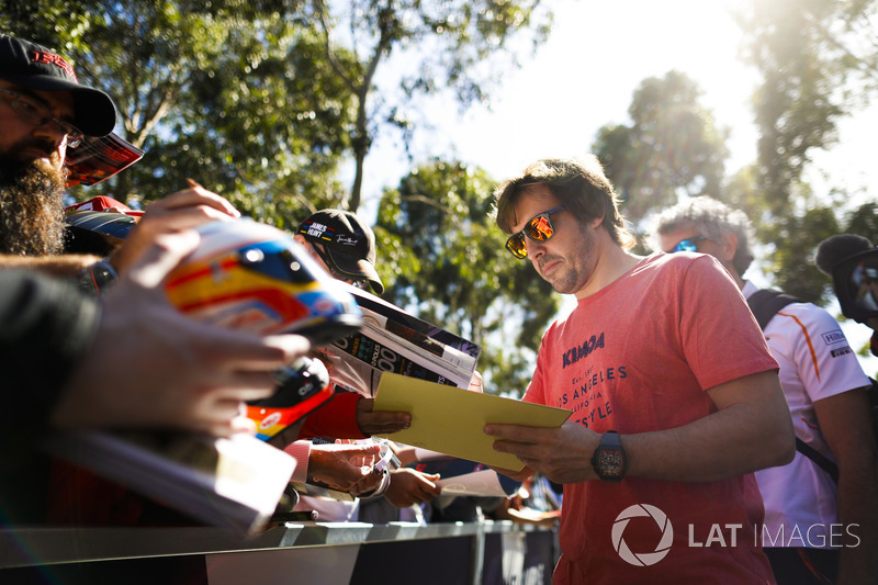 Fernando Alonso, McLaren, signs autographs for fans