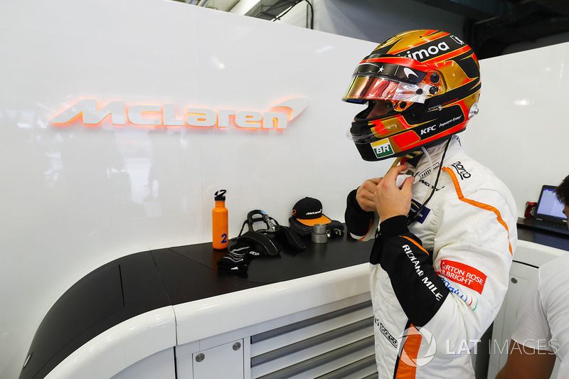 Stoffel Vandoorne, McLaren, adjusts his helmet strap