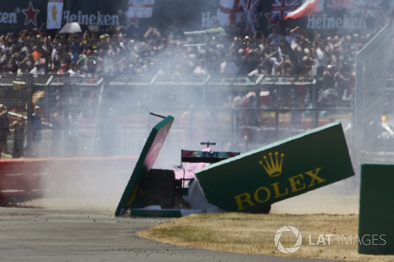 Sergio Perez, Force India VJM11, spins out and crashes through a trackside sign at the start