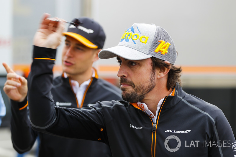 Stoffel Vandoorne, McLaren, and Fernando Alonso, McLaren, play darts