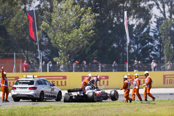 Romain Grosjean, Haas F1 Team, exits his damaged car after an opening lap accident