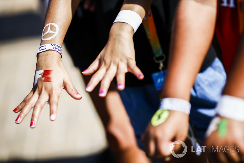 F1 and Ferrari logos painted on hands