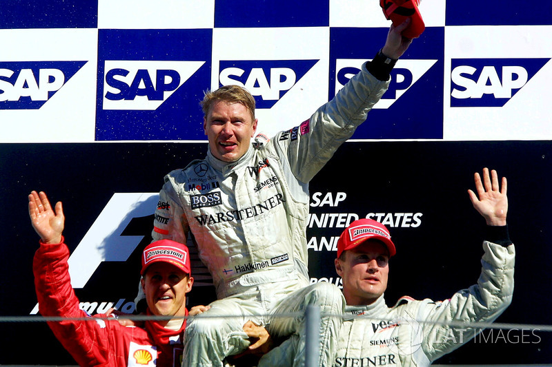 Podium: second place Michael Schumacher, Ferrari, Race winner Mika Hakkinen, McLaren, third place David Coulthard, McLaren