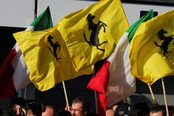 Ferrari celebrate at the podium with flags