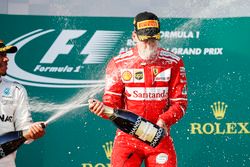 Lewis Hamilton, Mercedes AMG, 2nd Position, blasts Sebastian Vettel, Ferrari, 1st Position, with Champagne