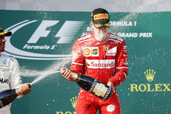 Lewis Hamilton, Mercedes AMG, 2nd Position, blasts Sebastian Vettel, Ferrari, 1st Position, with Champagne