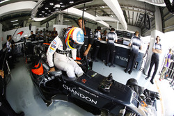 Fernando Alonso, McLaren MP4-31 climbs into his car in the garage.
