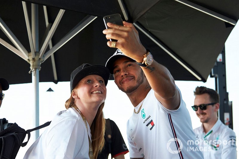 Lewis Hamilton, Mercedes AMG F1, takes a selfie with a fan