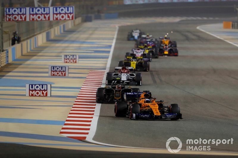 Carlos Sainz Jr., McLaren MCL34, leads Kevin Magnussen, Haas F1 Team VF-19, and Kimi Raikkonen, Alfa Romeo Racing C38