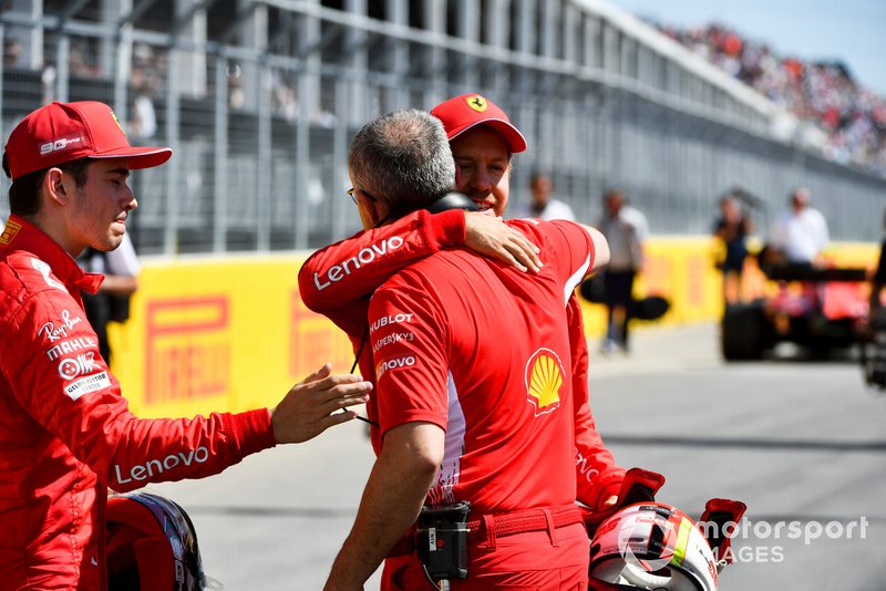 Charles Leclerc, Ferrari, and pole man Sebastian Vettel, Ferrari, celebrate with a colleague from Ferrari after Qualifying