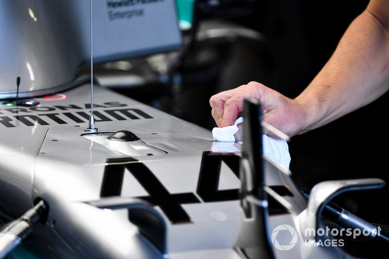 Car of Lewis Hamilton, Mercedes AMG F1 being cleaned by a mechanic
